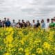 NathanJones-farm-tour-2026-posed-group-shot-in-canola-field